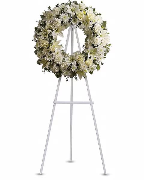 White floral wreath on a standing easel