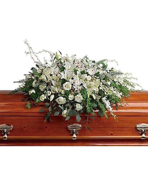 White floral casket spray with roses and lilies