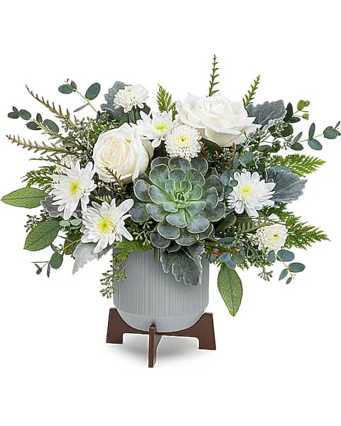 White roses and daisies arranged with a succulent in a gray vase