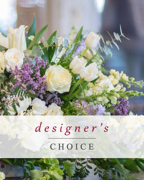 White and lavender floral arrangement with mixed blooms and greenery