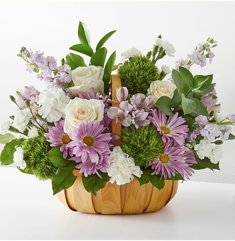 Lavender daisies and white roses in a wooden basket