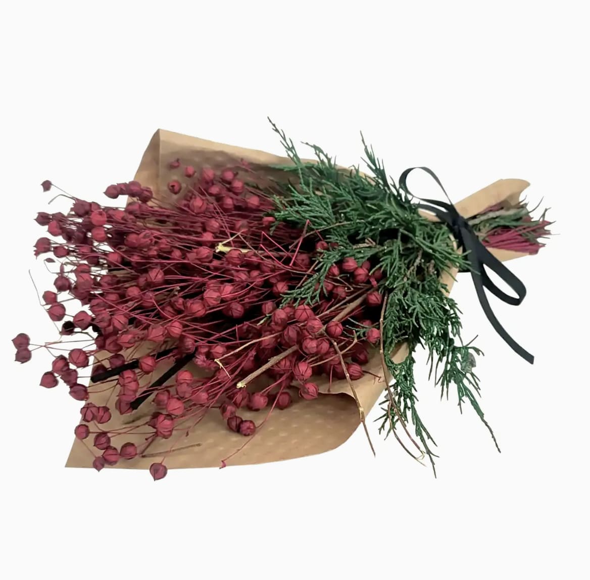 Bundle of red dried flowers wrapped in brown paper with a black ribbon