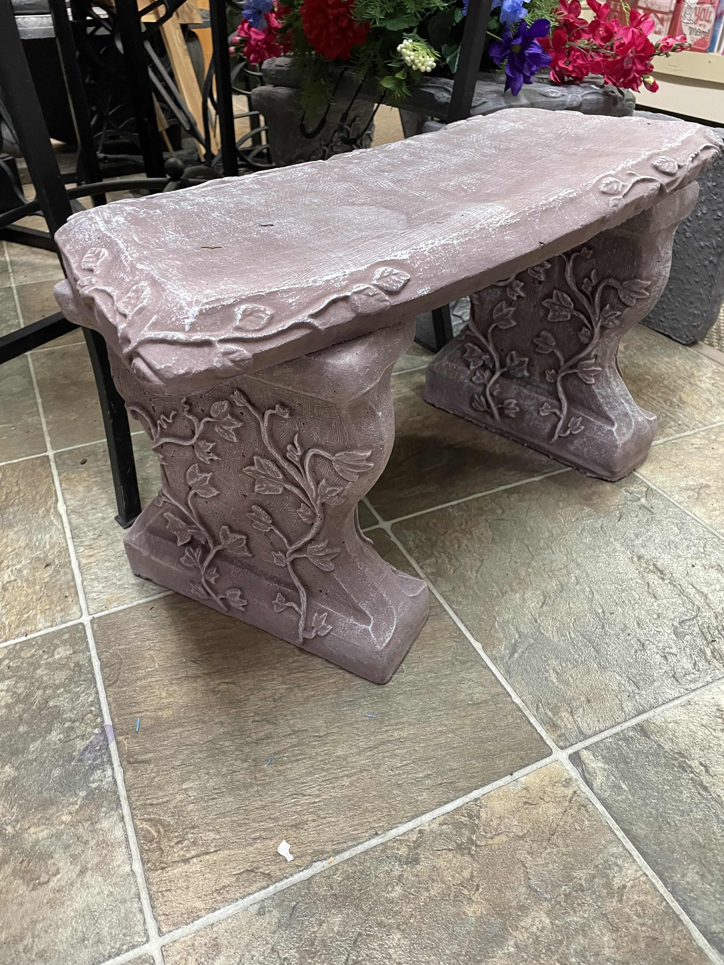 Decorative stone bench with vine carvings