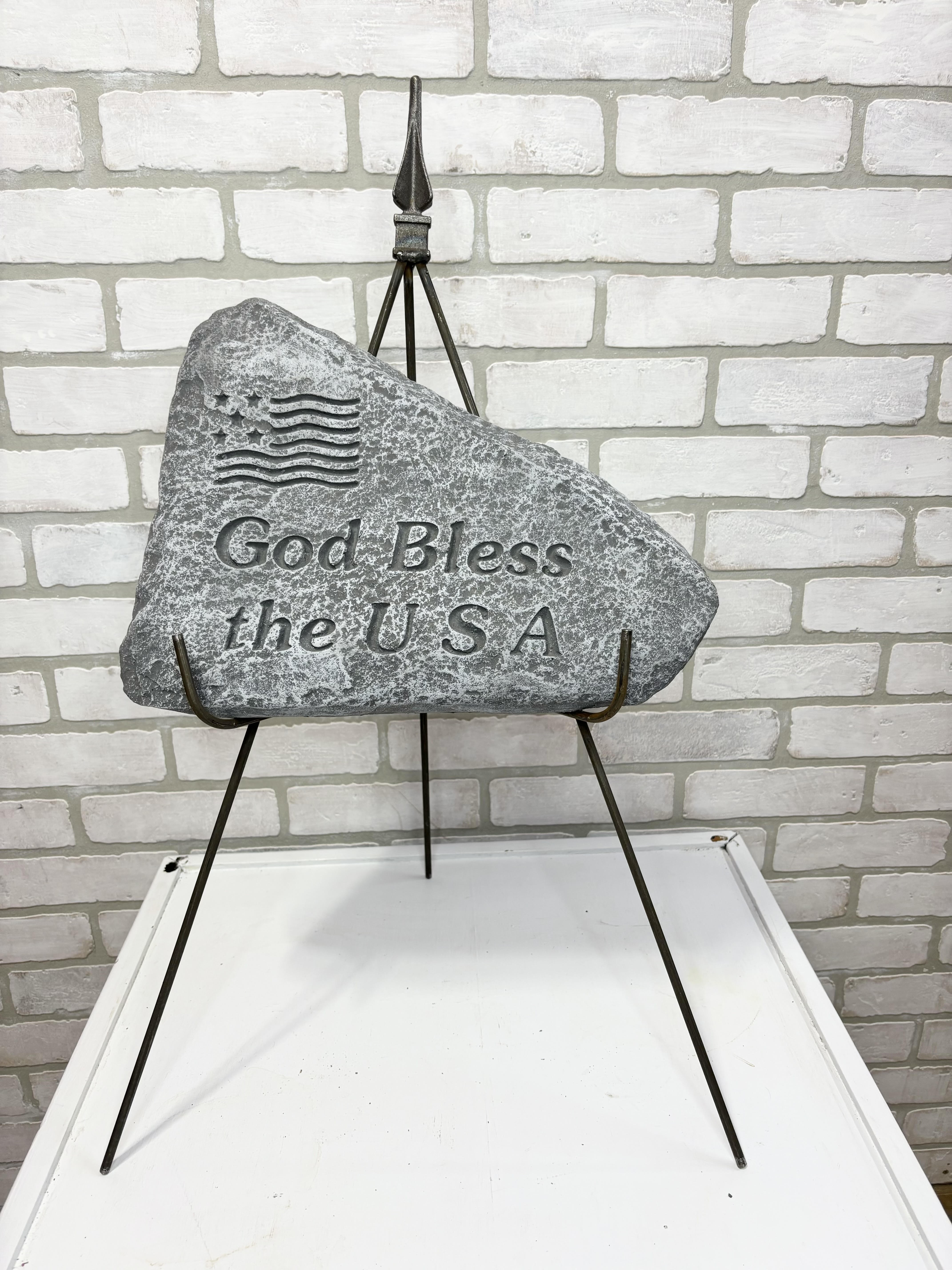 Stone memorial plaque on a metal stand with engraved text