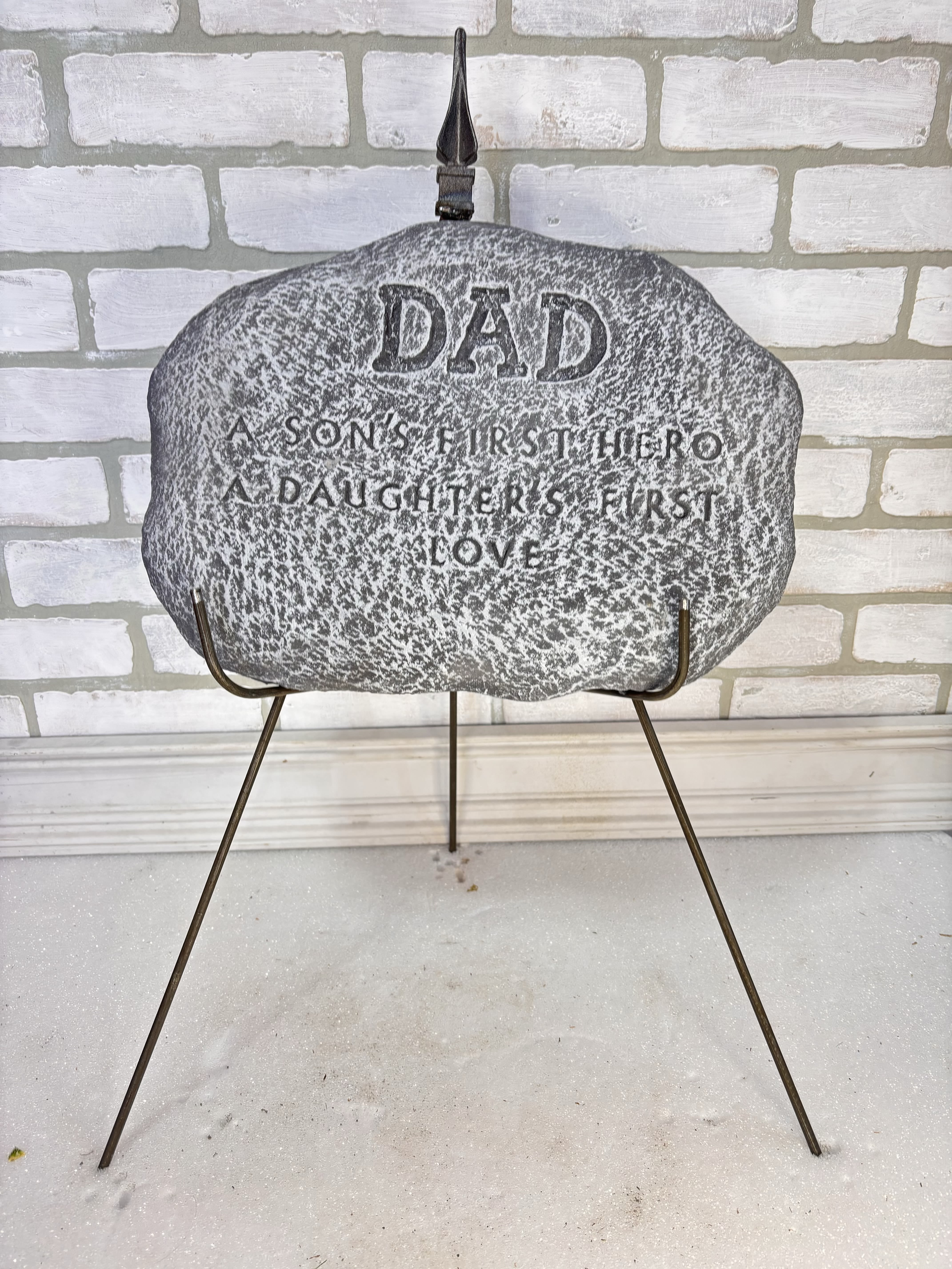 Memorial stone on a metal stand with engraved text for Dad