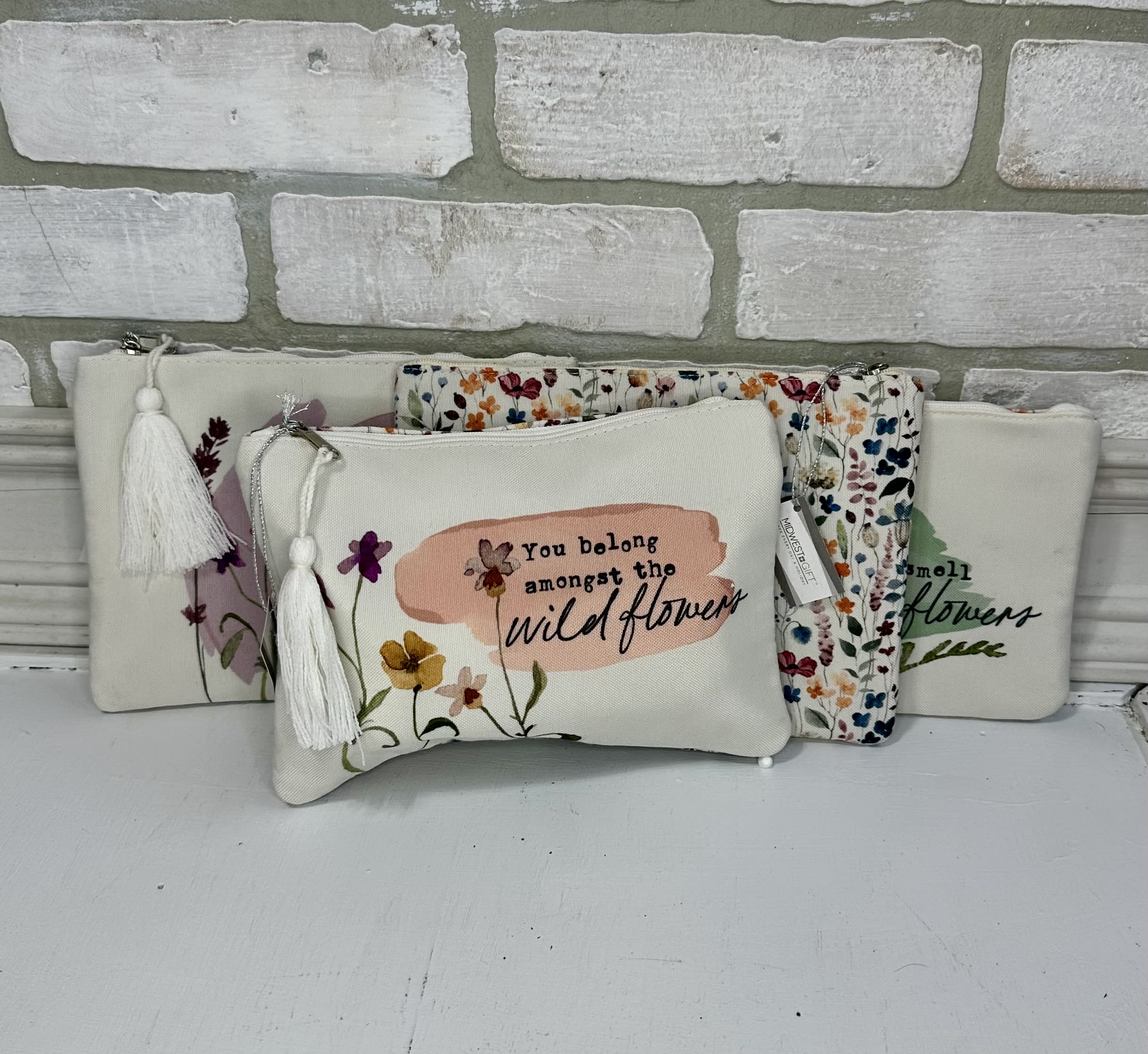 Floral zip pouches with tassels and printed wildflower designs