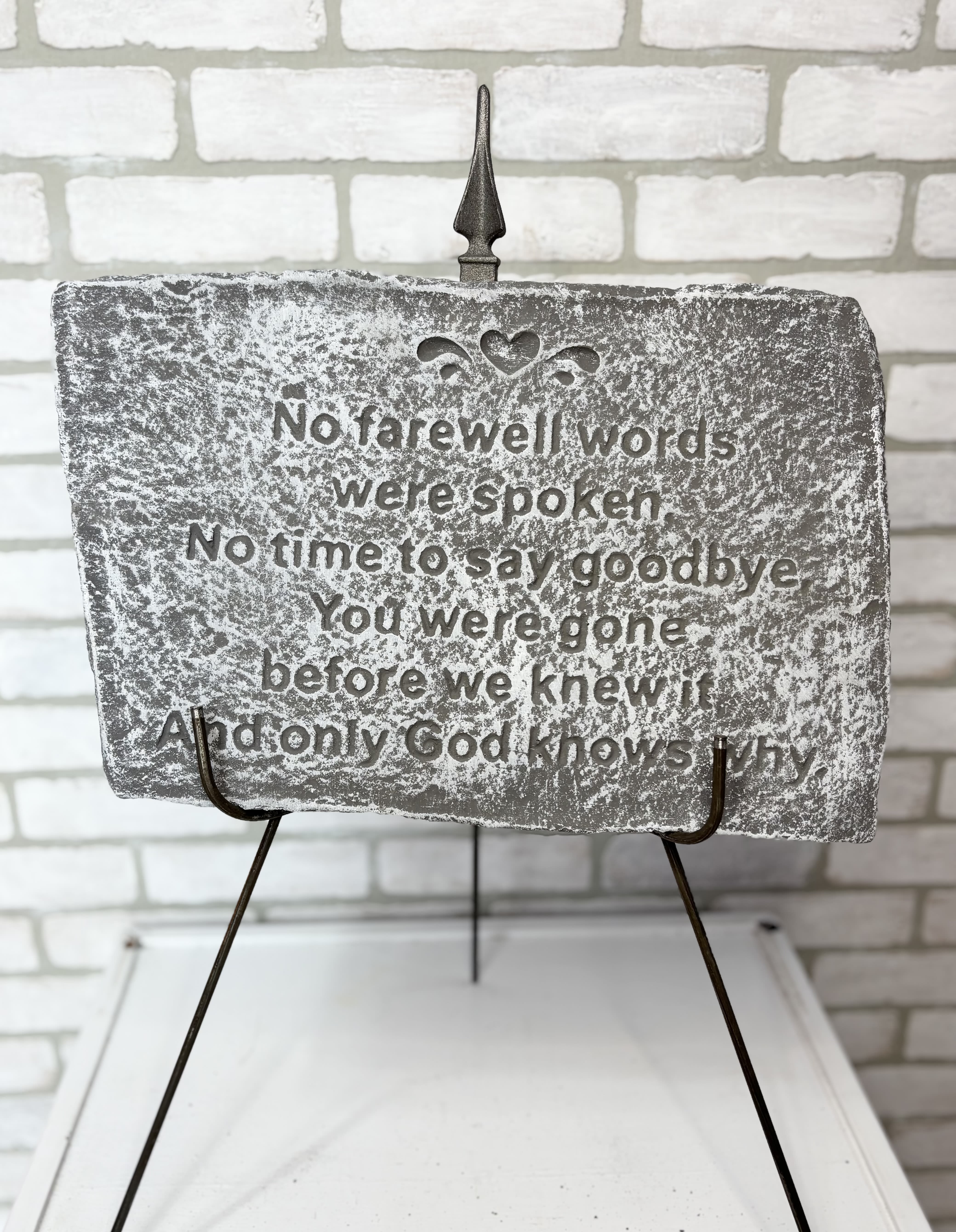 Memorial plaque with a sympathy quote on a metal stand
