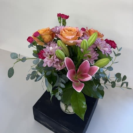 Forever My Sunshine - Forever My Sunshine is a vibrant arrangement designed to brighten any day. Featuring cheerful pink lilies, lavender daisies, orange roses, and hot pink carnations, this colorful bouquet is full of warmth, joy, and heartfelt sentiment. Arranged in a vase, it's the perfect gift to celebrate a birthday, send get-well wishes, say thank you, or simply let someone know they're always in your thoughts. Handcrafted with the freshest blooms, Forever My Sunshine is sure to bring a smile that lasts long after it's received.