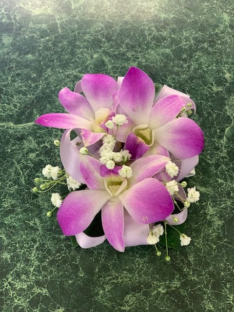 Pink and white orchid bouquet with small white filler flowers