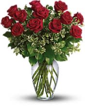 Red roses arranged in a clear glass vase