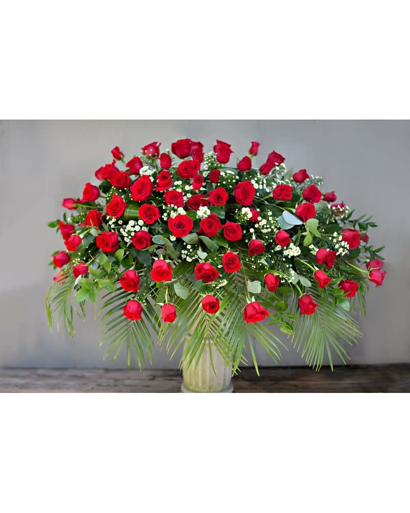 Large arrangement of red roses in a glass vase