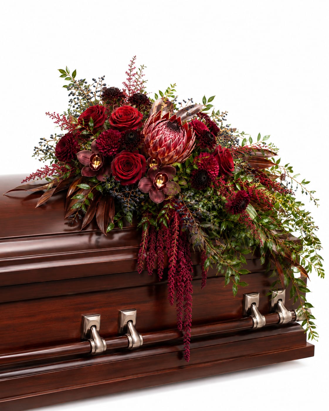 Deep red floral spray on a polished wooden casket