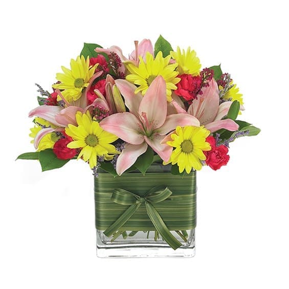 Home Is Where The Heart Is - Brighten your place and theirs, instantly, with a burst of color brought to life by daisies, mini carnations and Asiatic lilies in a handsome rectangular glass vase. Measures 16"H by 12"L.