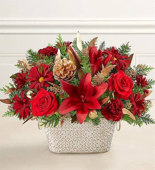 Red floral arrangement in a patterned white container