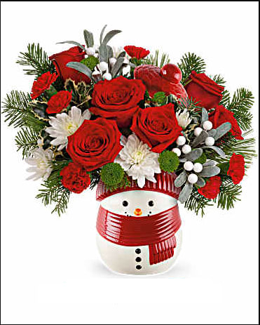 Red roses and white flowers arranged in a snowman vase with a red scarf