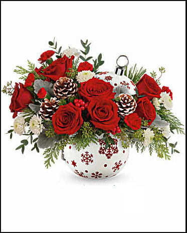 Red roses and white flowers in a snowflake-decorated vase
