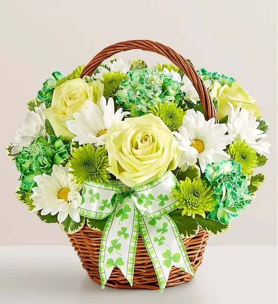 Basket of white and green flowers with a shamrock ribbon