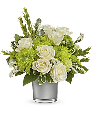 White roses and green mums arranged in a clear glass vase