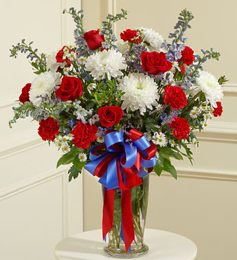 Beautiful Blessings Vase Arrangement patriotic - Product ID: 91300   91300 Red White and Blue Large Sympathy Vase Arrangement Send a patriotic tribute to a beloved veteran with this red, white and blue arrangement. Features the freshest red roses, white cremones, blue delphiniums and more Accented with myrtle, spiral eucalyptus and more Presented in a classic clear glass vase Our florists choose only the freshest flowers available, so colors and varieties may vary Vase measures 11"H Arrangement measures approximately 26âH