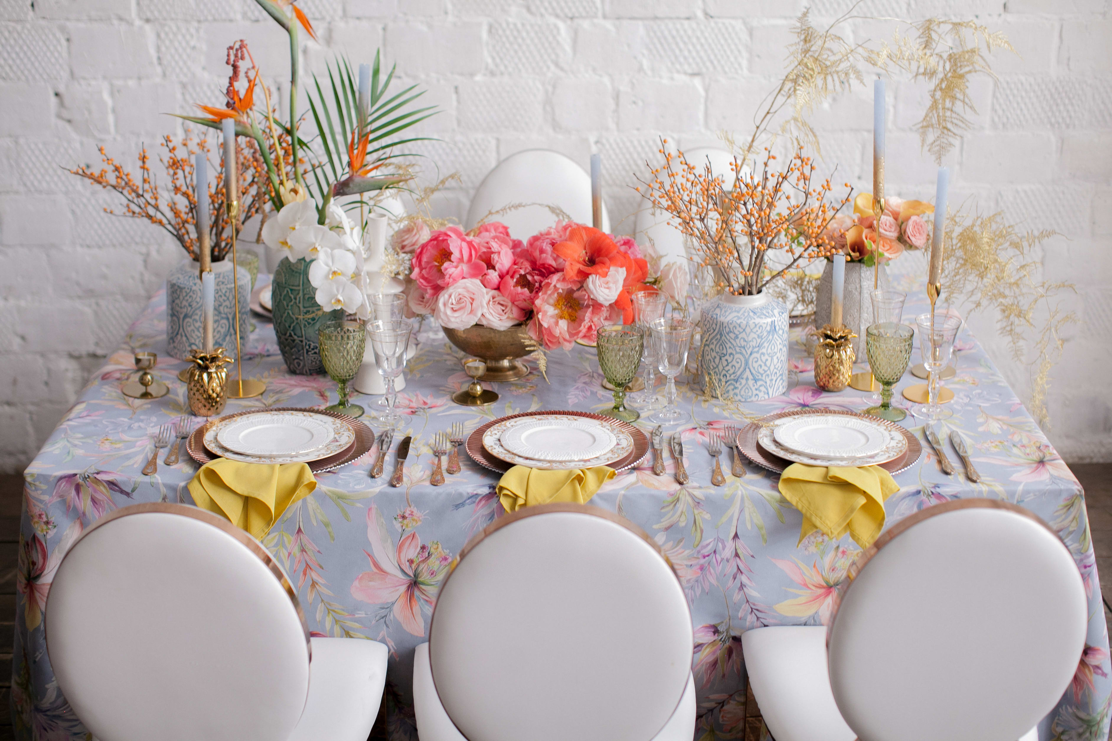 Floral table centerpiece with pink and orange flowers on a decorated dining table