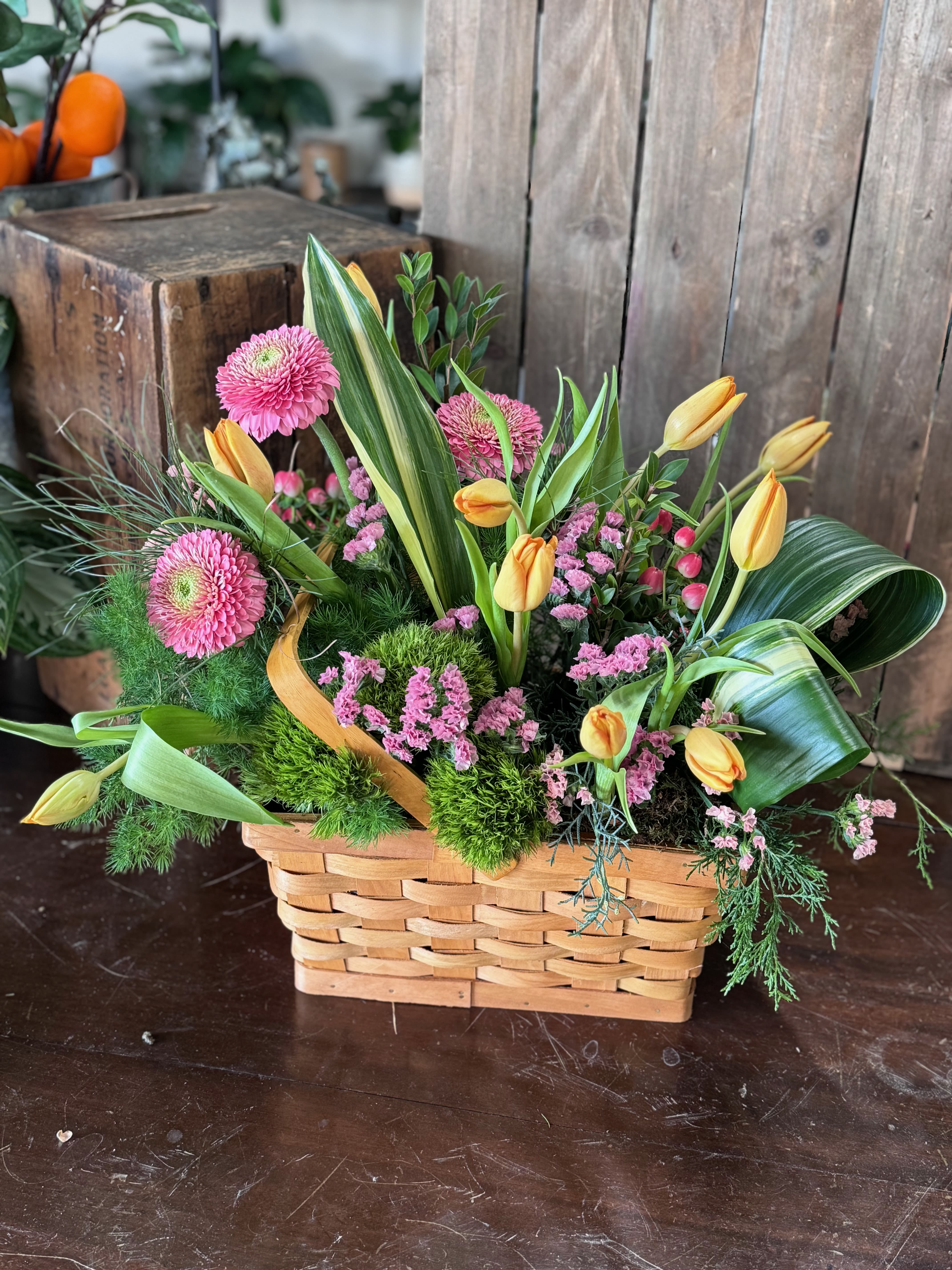Spring in Bloom – Basket | Spring Flower Basket - Bring the beauty of the season indoors with our Spring in Bloom Basket, a lush spring flower arrangement filled with bright pastel blooms and fresh seasonal flowers. Overflowing with soft textures and cheerful colors, this spring flower basket feels as if the flowers were just picked from a sun-kissed meadow. Some blooms may even be locally grown, making each arrangement uniquely fresh and abundant.  Designed in a charming basket, this garden-inspired arrangement is perfect for Easter flowers, a thoughtful sympathy flower basket, birthday flowers, new baby celebrations, congratulations, or sending a joyful just because flower gift.  A little piece of spring to brighten any space—this Spring Flower Basket brings the outdoors in and makes every occasion feel special.  Available for flower delivery in Ooltewah, Chattanooga, Collegedale, and surrounding Tennessee areas.  Flowers and or baskets may vary according to availability.  Product ID: Spring-in-bloom-basket