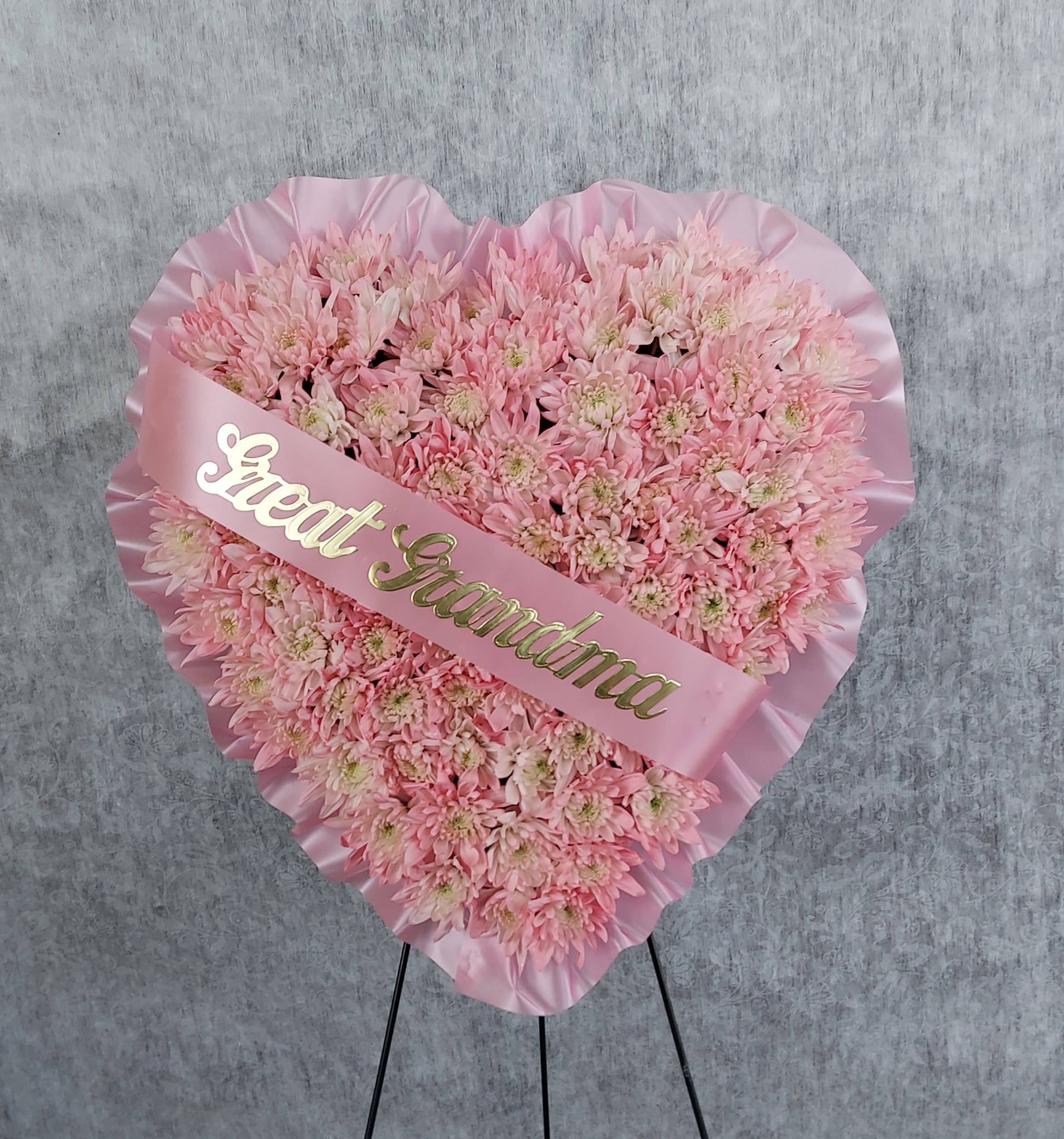 Heart-shaped pink chrysanthemum arrangement with a "Great Grandma" sash