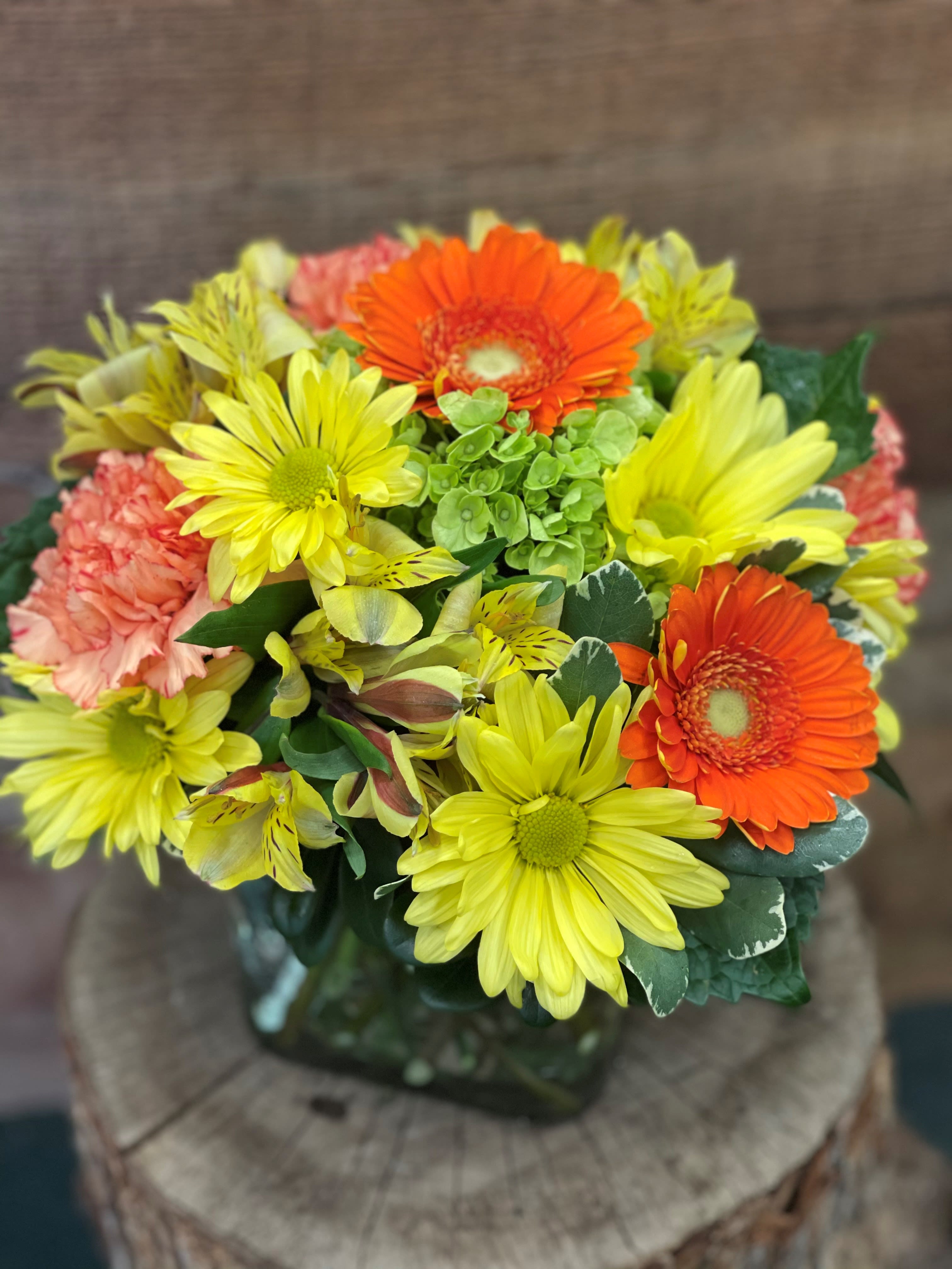 Bouquet of yellow and orange daisies with pink carnations