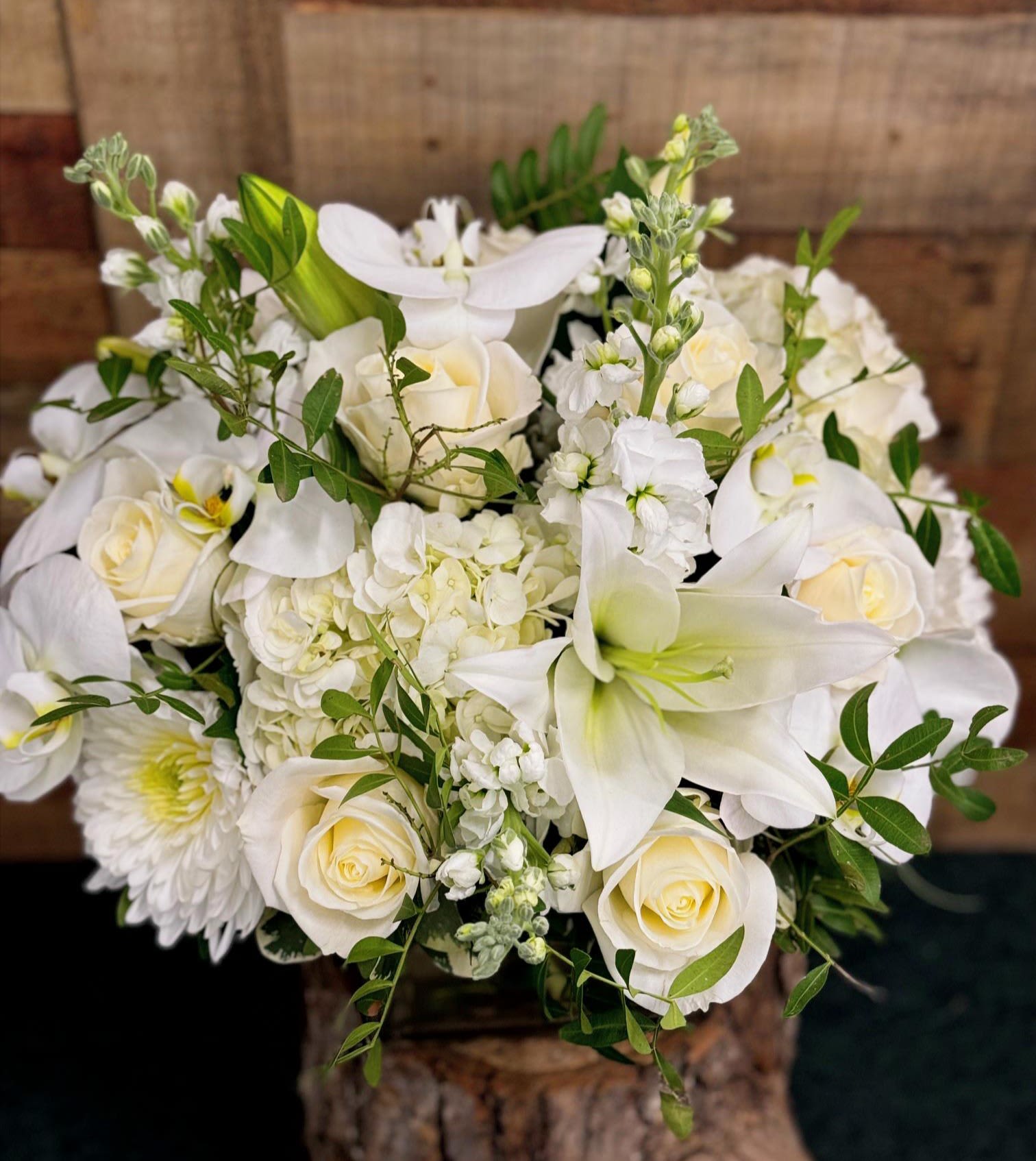 White floral bouquet with roses, lilies, and hydrangea