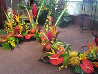 Tropical floral arrangements with red anthuriums and orange bird-of-paradise flowers