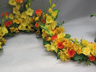 Yellow and red floral garland arranged in a curved shape