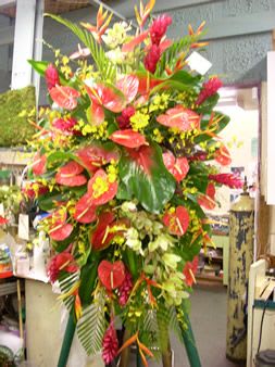 Tall tropical flower arrangement with red anthuriums and bird of paradise