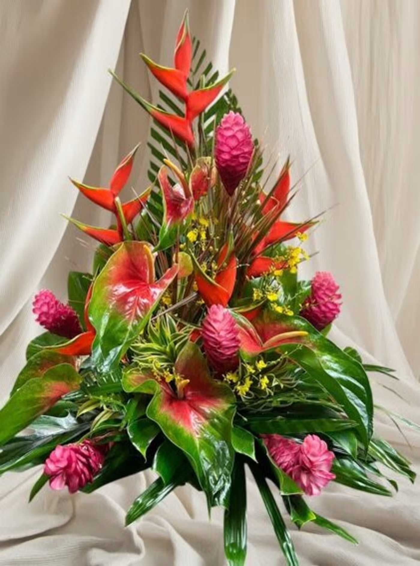 Tropical bouquet with red heliconia and pink ginger flowers