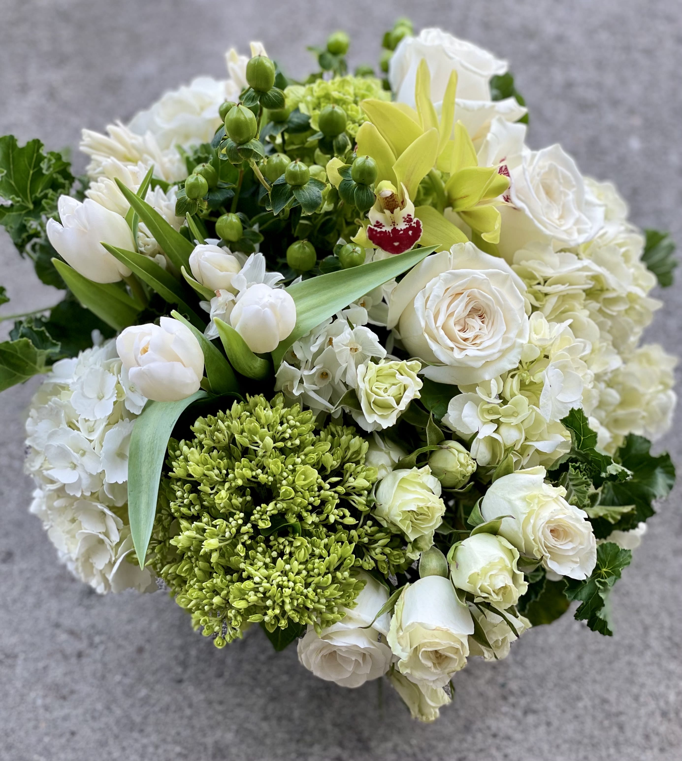 Crisp + clean  - A full upscale arrangement of lush white and green florals for a coffee table or large dining table. Very clean + chic. Designers choice, large and lush in ti leaf lined vase. Picture may not exact due to market availability but it will be close! If anything is extremely important to you let us know. Please email us with any questions you may have to info@fleurtstyle com   Saturday and Same Day are available if you call the shop.   ** 415 751 2747 10:00AM -5:00PM  