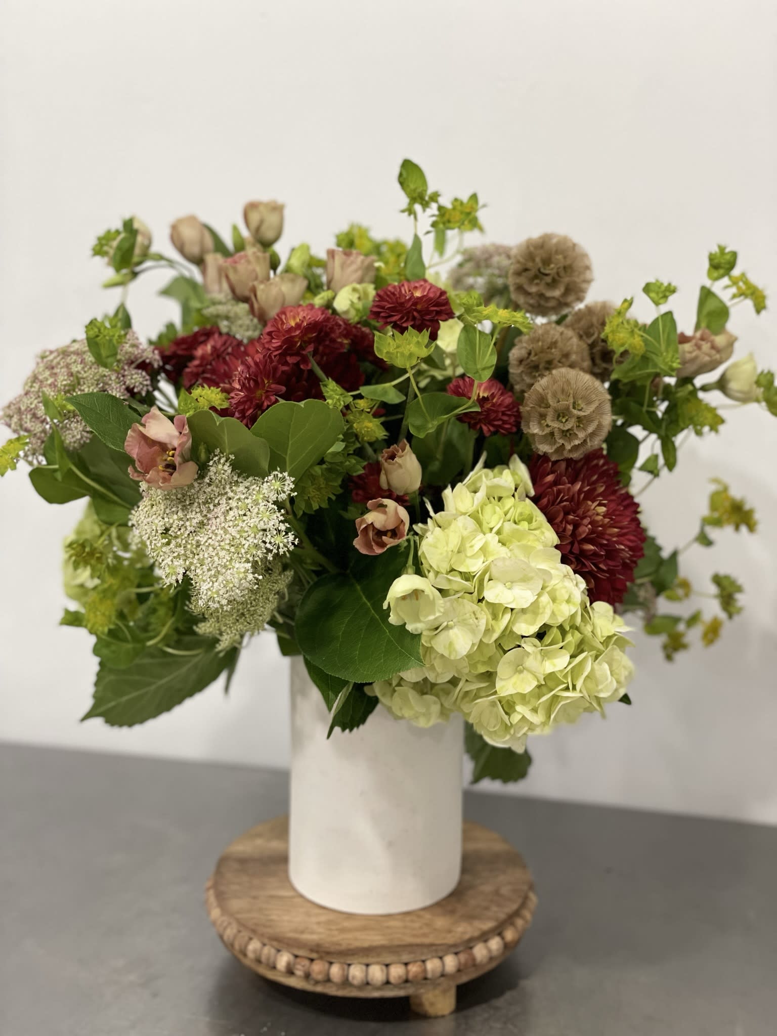 Hostess with the Mostess  - Give the gift of flowers for the bar cart or the sideboard. This is a neutral number with green, white and browns for a lovely hostess gift.   Designers choice, large and lush in ti leaf lined vase. Picture may not exact due to market availability but it will be close! If anything is extremely important to you let us know. Please email us with any questions you may have to info@fleurtstyle com      