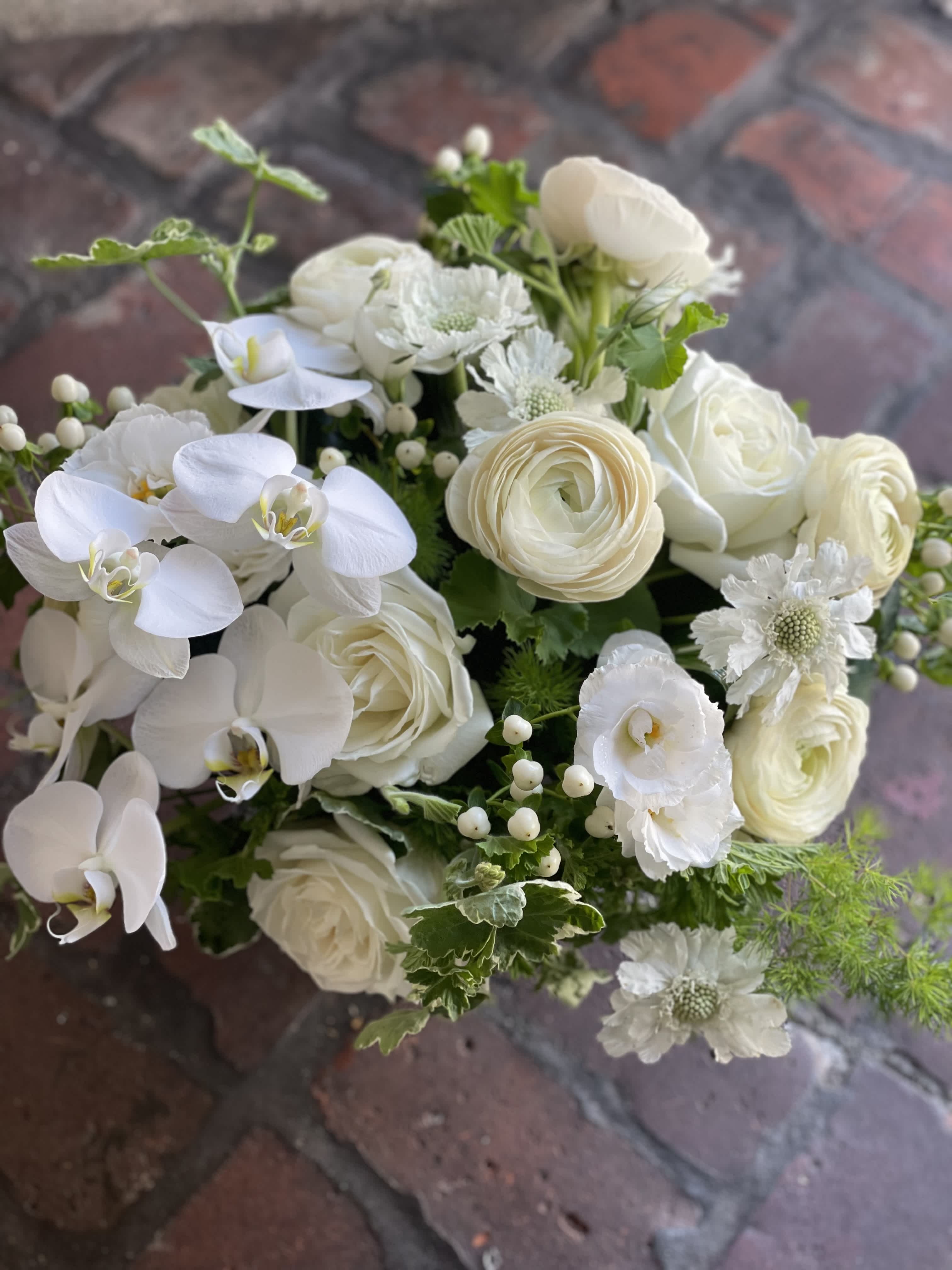 Faith  - Low and lush with premium blooms. Perfect for a coffee table or dinner table. For the person with exquisite taste in clean white florals. Designers Choice in premium white blooms. Saturday and Same Day are available if you call the shop.   ** 415 751 2747 10:00AM -5:00PM 