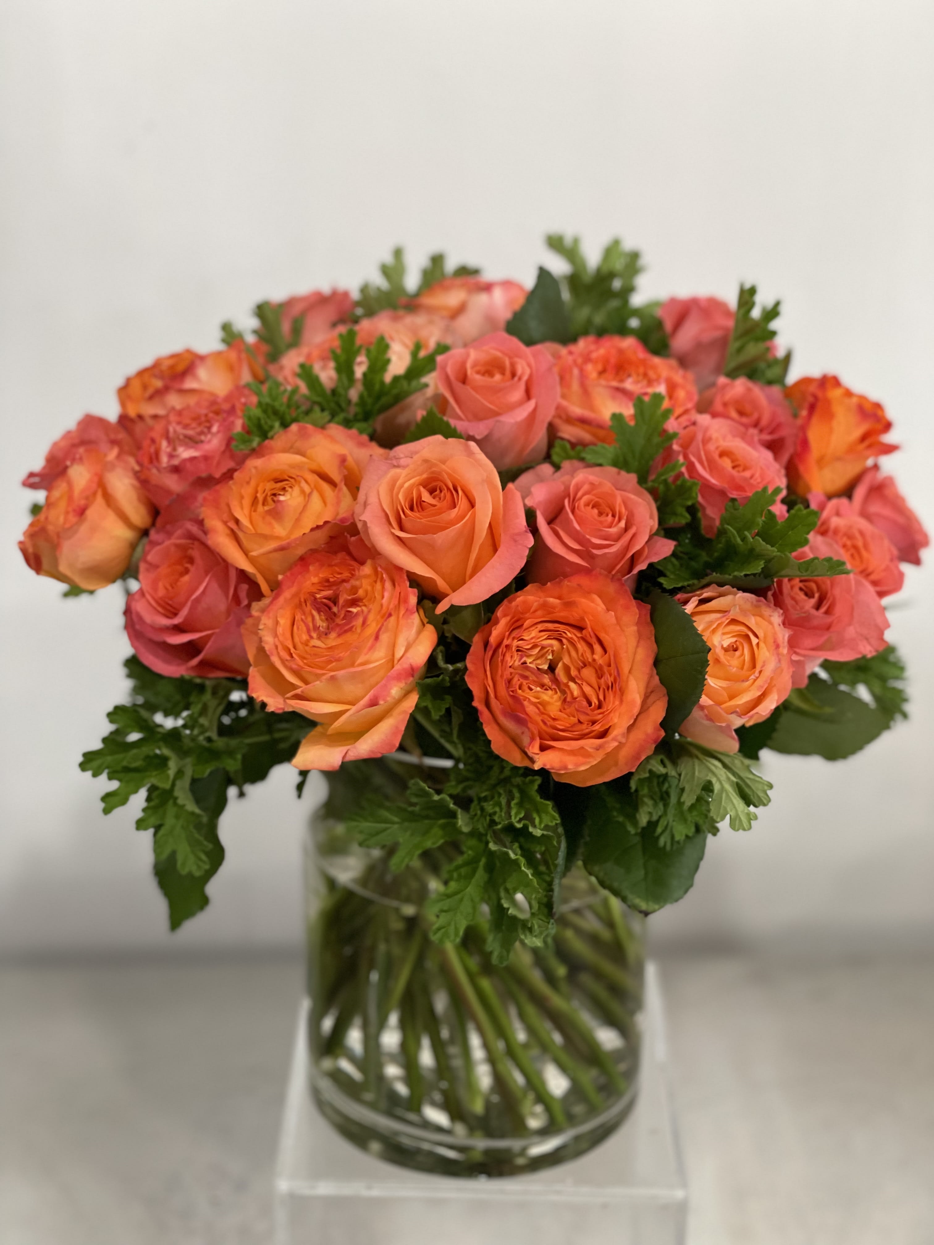 Florence  - This is simple compose but makes an impact. This is full of garden roses and fresh greens in a til leaf lined vase. This is perfect for someone who enjoys flowers with a little bit of height and a simple, but modern bold color palette.   Saturday and Same Day are available if you call the shop.   ** 415 751 2747 10:00AM -5:00PM MOTHER'S DAY DELIVERIES ARE LIMITED SO ORDER EARLY! PLEASE CALL THE SHOP TO PLACE ORDER IF THEY NEED TO BE TIMED*     
