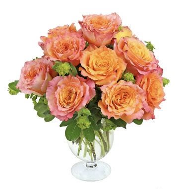 Bouquet of peach and pink roses in a clear glass vase