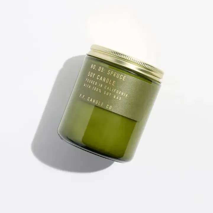 Green soy candle in a glass jar with a metal lid