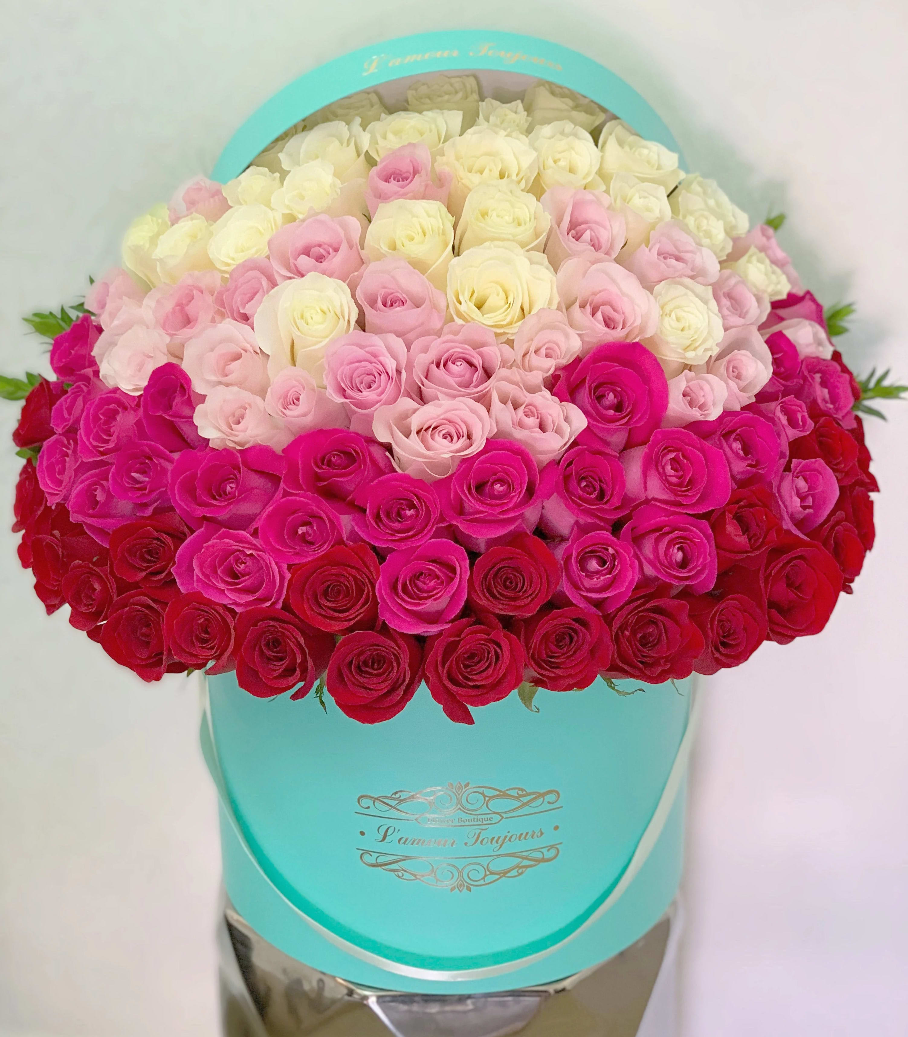 Heart-shaped box filled with pink, white, and red roses