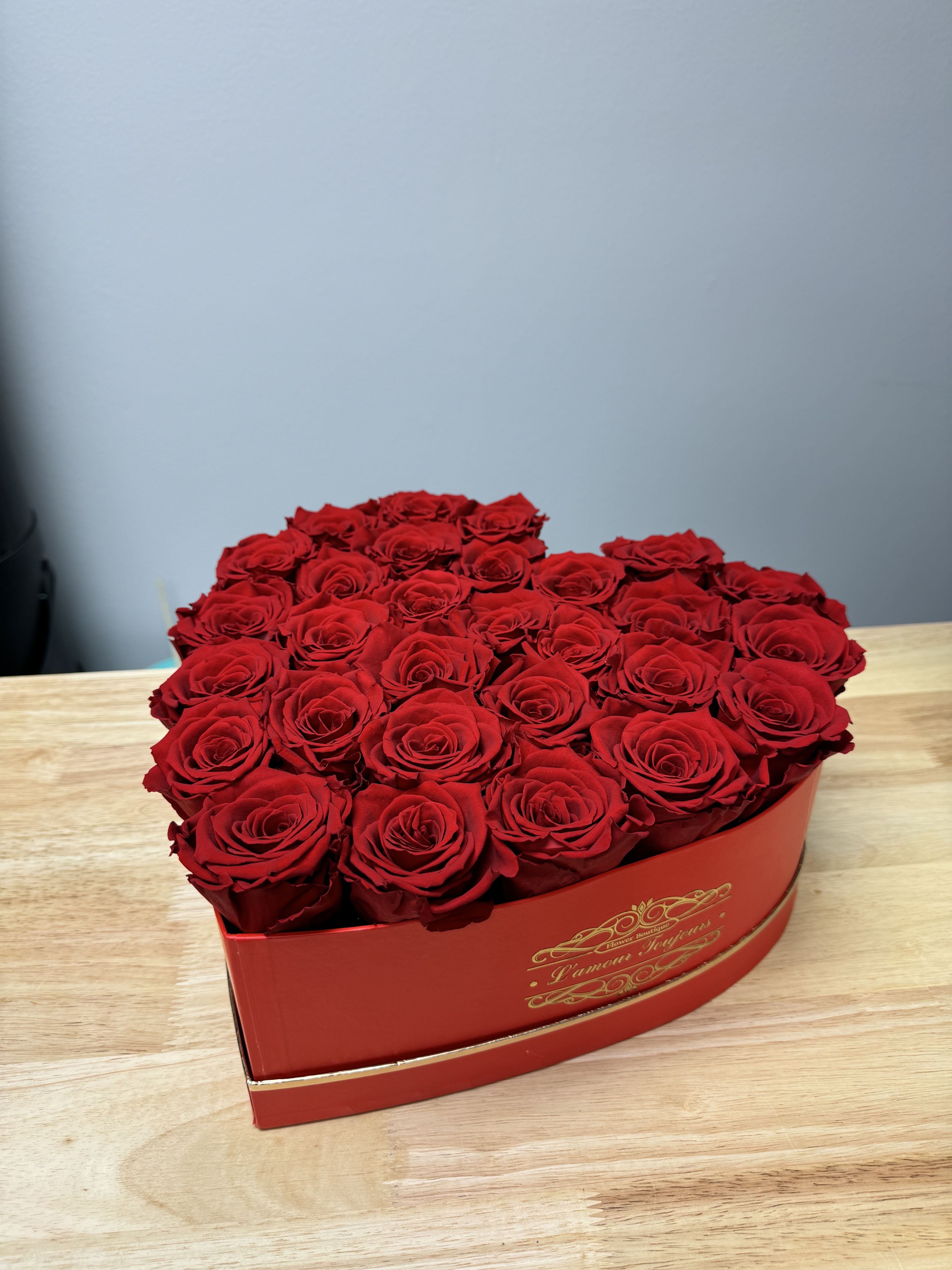 Heart-shaped box filled with red roses