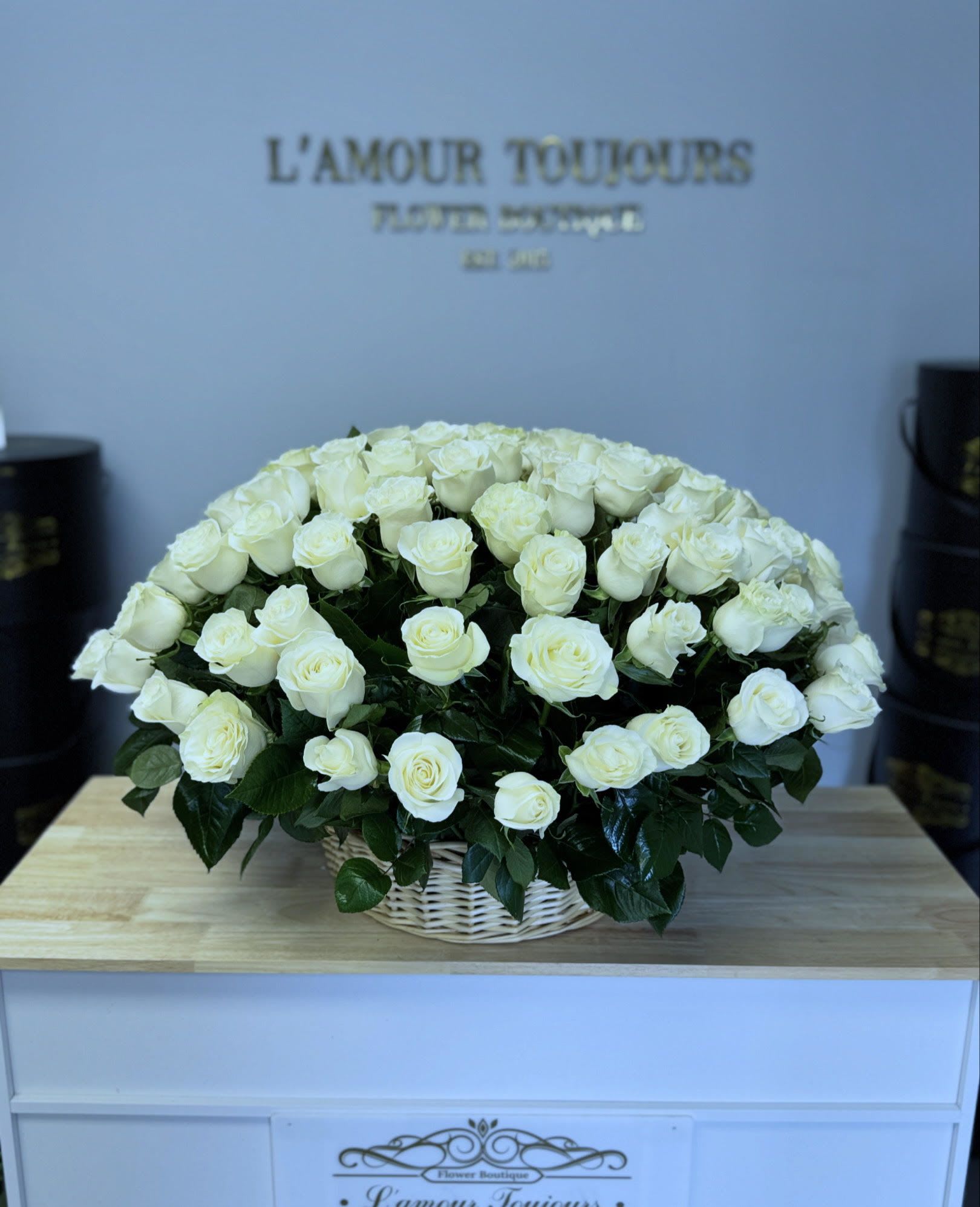 Large basket of white roses on a table