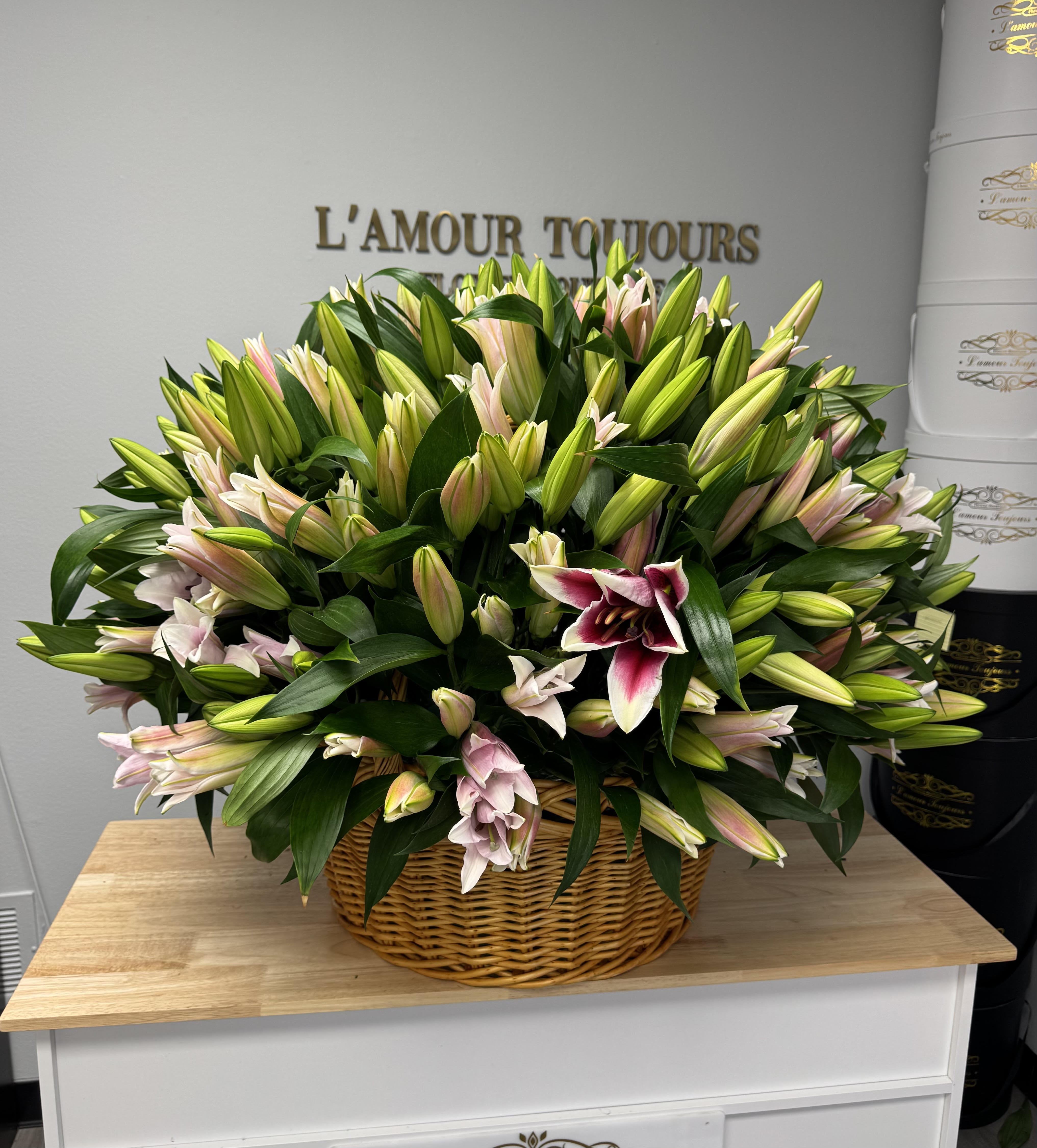 Basket of pink and white lilies with many unopened buds