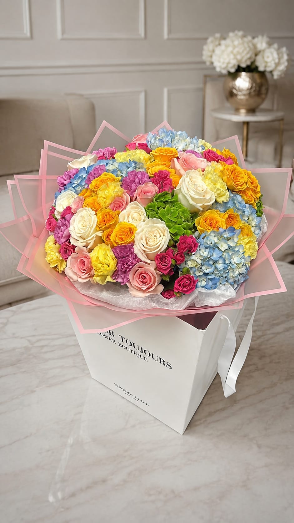 Large bouquet of multicolored roses and hydrangeas in a white gift box
