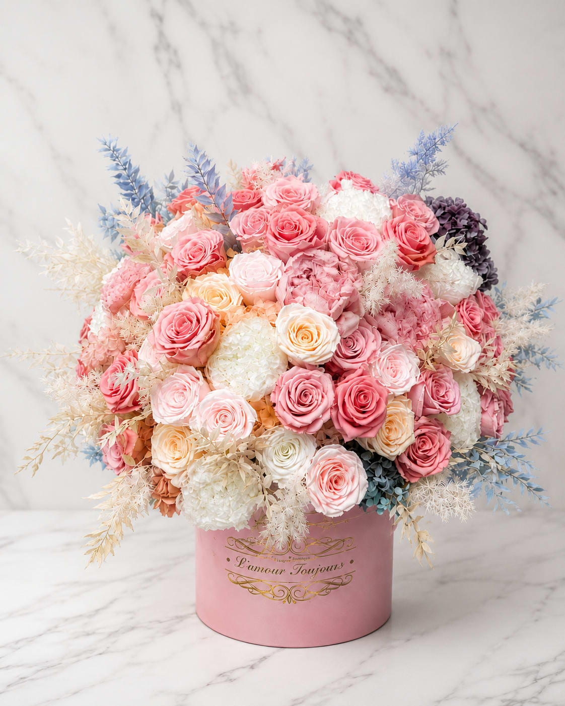 Pink and white rose arrangement in a round pink box