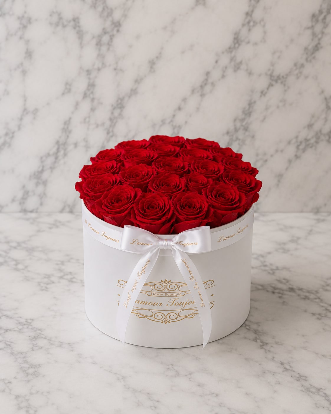 Round box of red roses tied with a white ribbon
