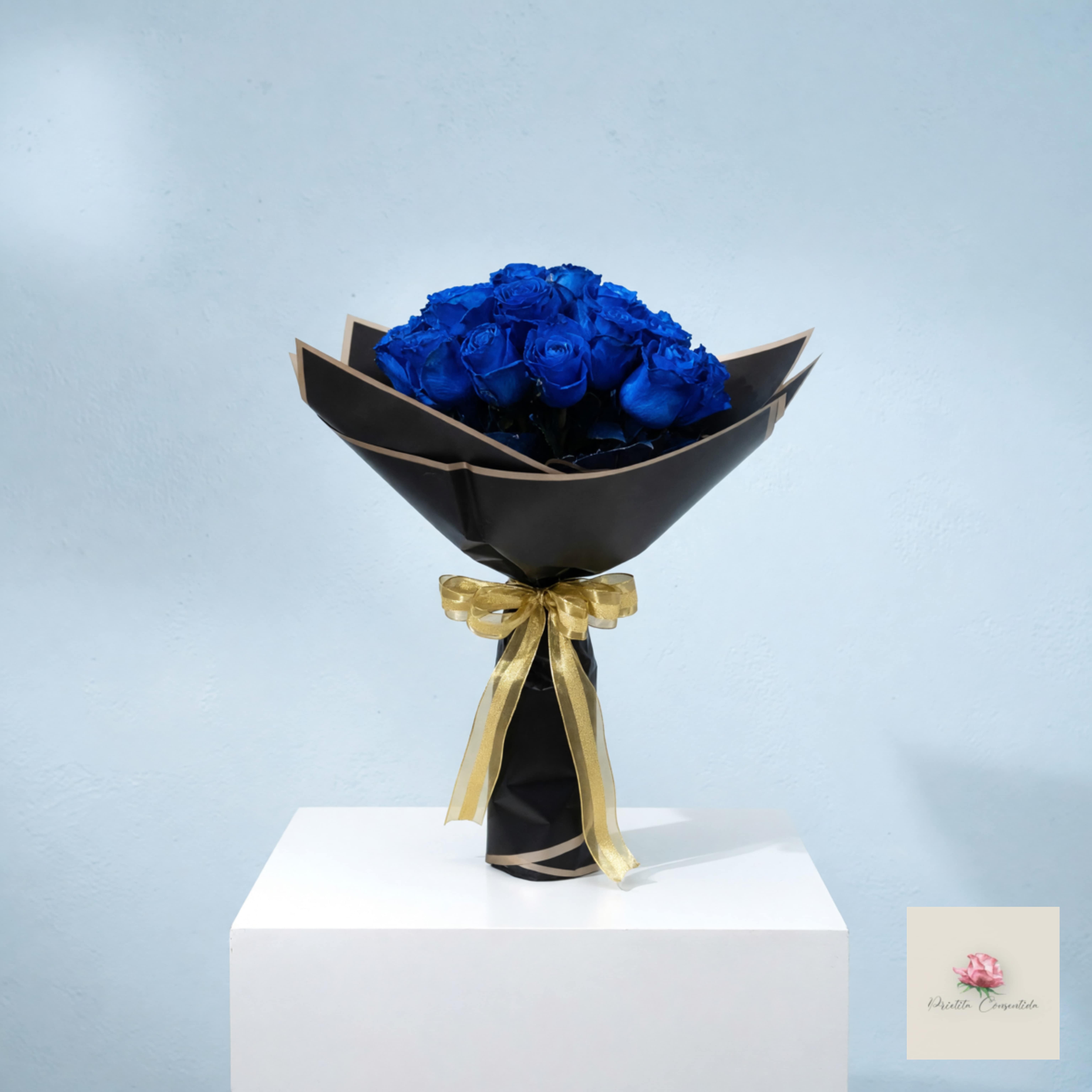 Bouquet of blue roses wrapped in black paper with a gold ribbon