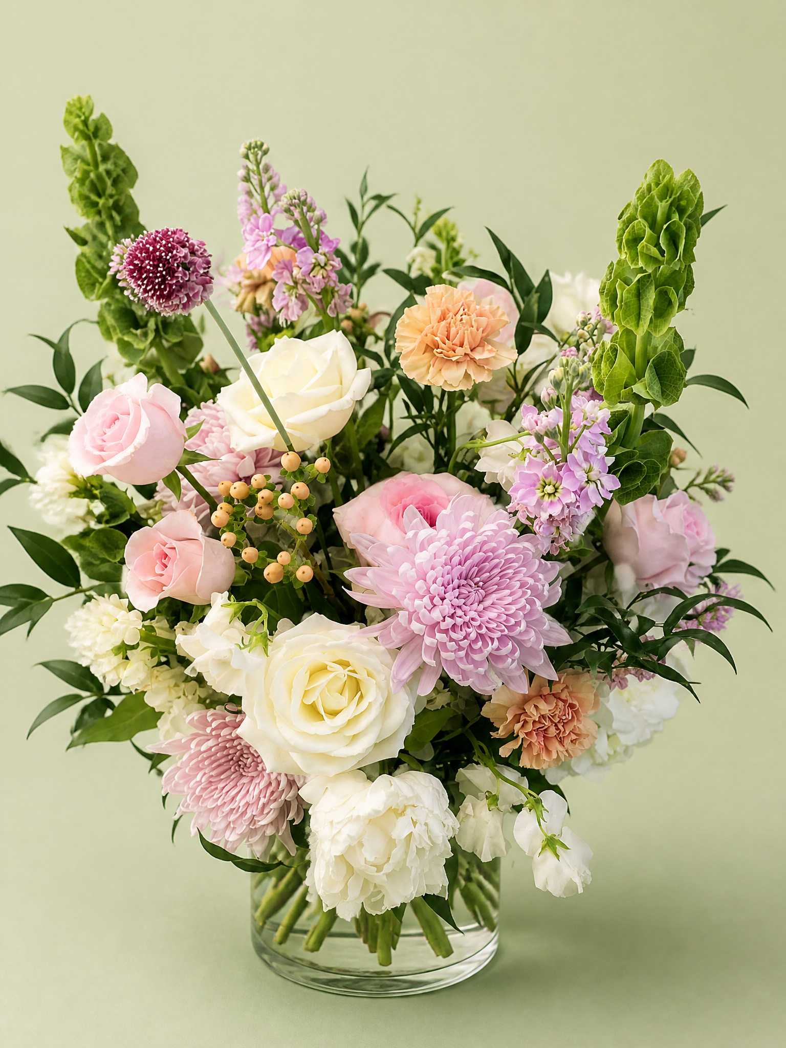 Pastel mixed flower arrangement in a clear glass vase