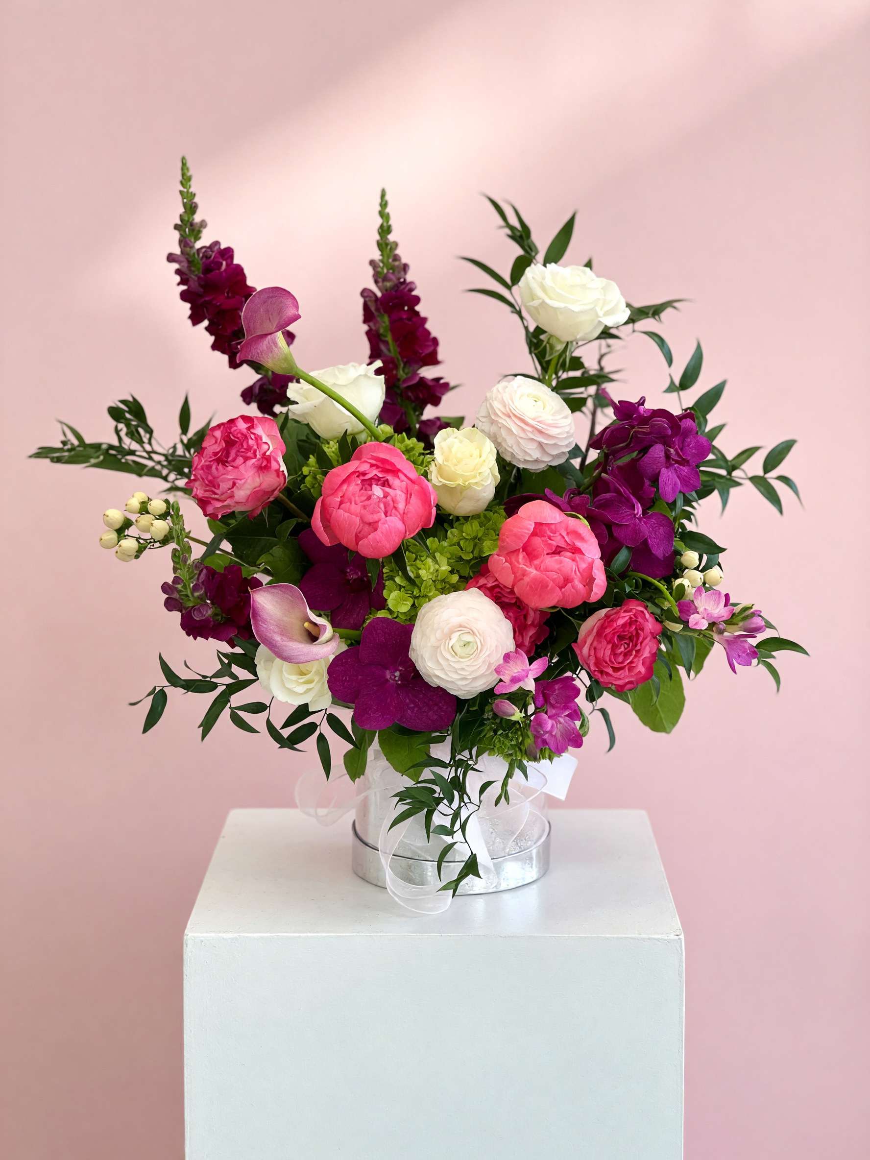 Pink and white mixed bouquet in a clear vase