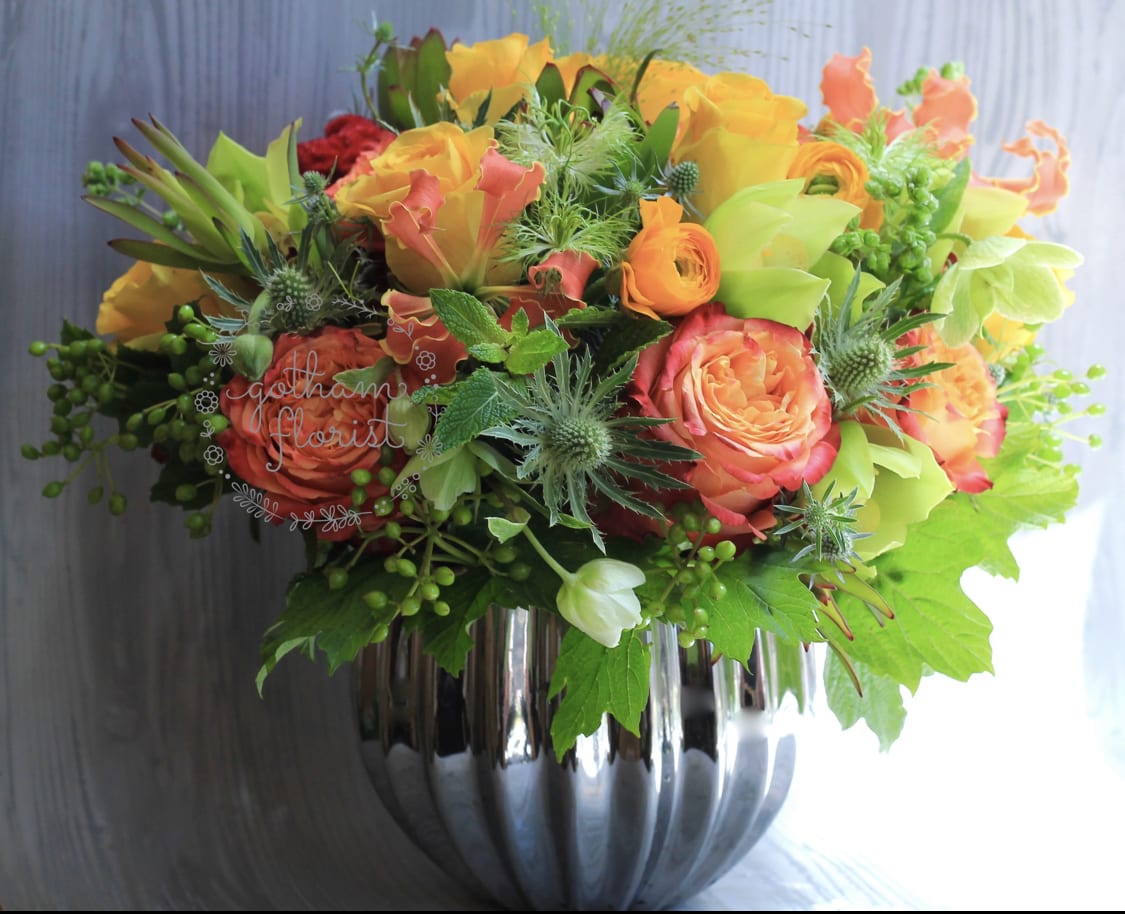 Sun and Stars - Large silver vase filled with bright yellow, orange and green blooms. A perfect gift to say thank you! Send the best flowers from the best manhattan florist. Same day delivery!