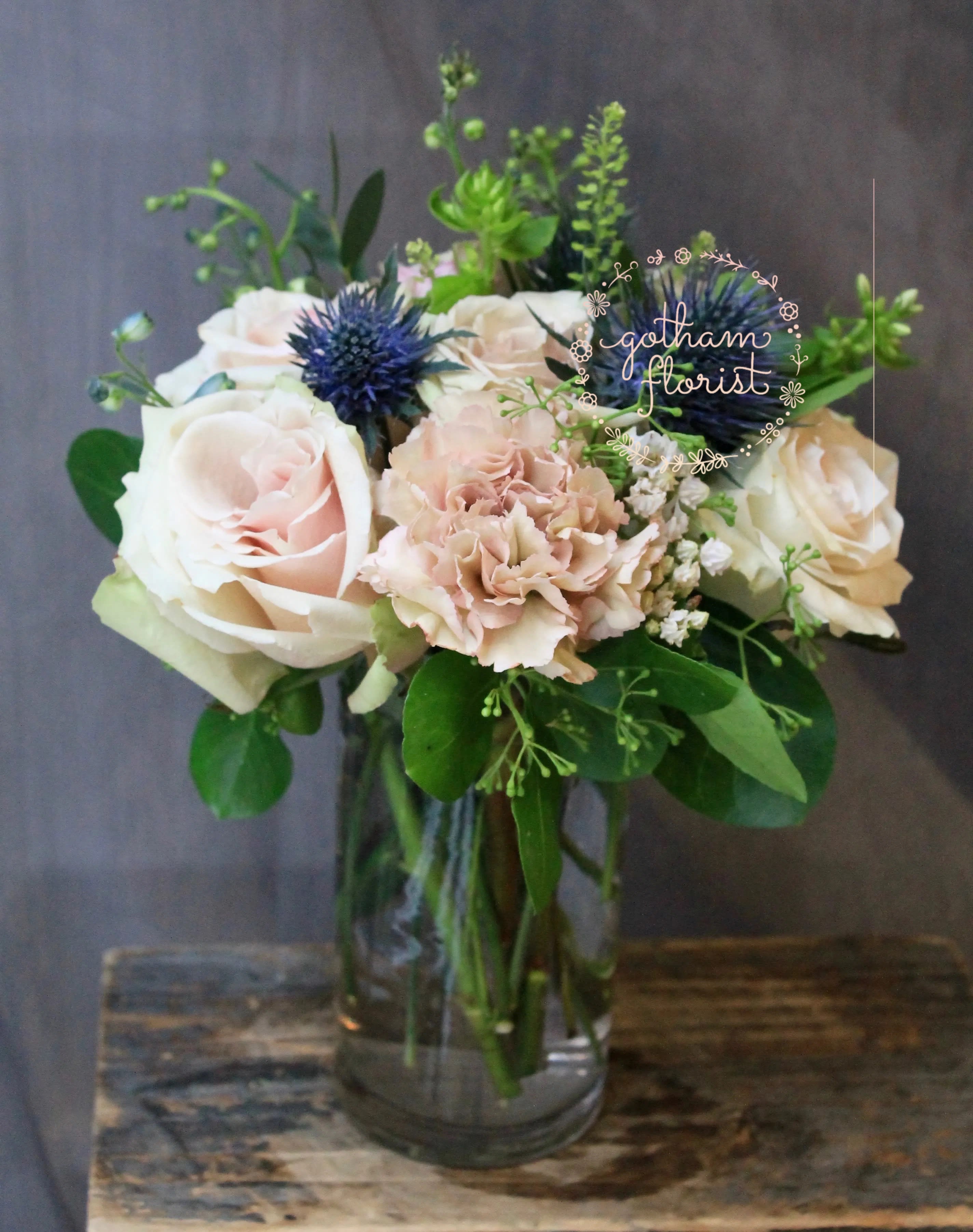 Cutie - Cute glass vase with roses, carnations and thistle. The thistle is a unique flower that is naturally blue and also adds a little funky vibe.  We offer same day flower delivery in Manhattan, Queens, Bronx, Brooklyn, Staten Island and West Chester counties. We have the prettiest and most luxurious flowers to choose from and our designs are unique and whimsical. We carry Peonies almost every day of the year!! Best florist, nyc, local florist, send flowers, flower delivery, same day delivery, florist around me, flower shop, best flower shop, flowers, flower delivery, peony, peonies, same day flower delivery,  wedding florist, best florist nyc, nyc florist, florist near me, manhattan florist,  brooklyn florist 